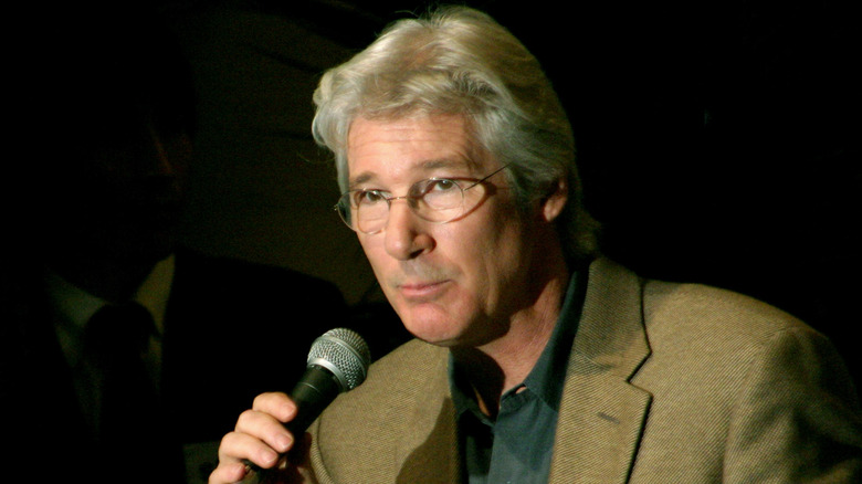 Richard Gere holding a microphone