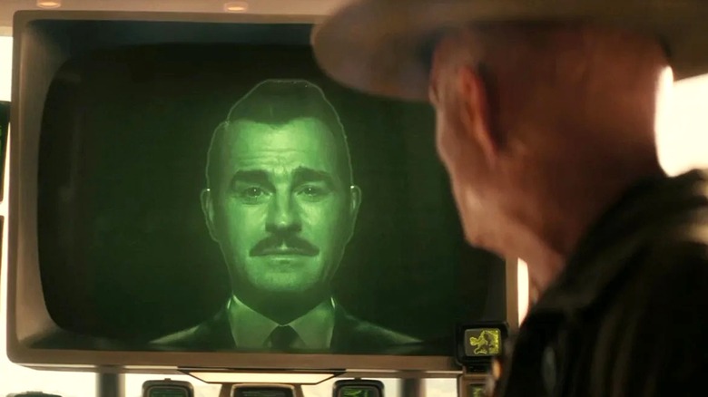 Robert House appearing on a screen to interact with the Ghoul in 