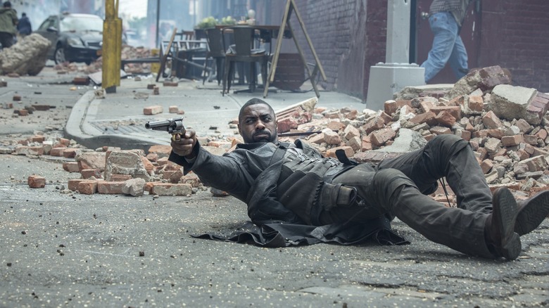 The Gunslinger on the ground, aiming his gun in "The Dark Tower"