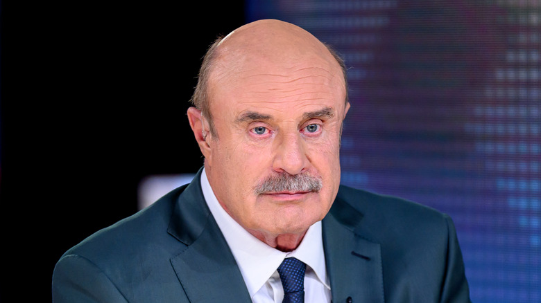 Dr. Phil sitting, with a serious look on his face
