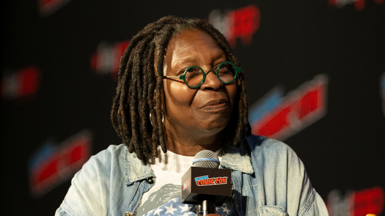 Whoopi Goldberg at holding a microphone