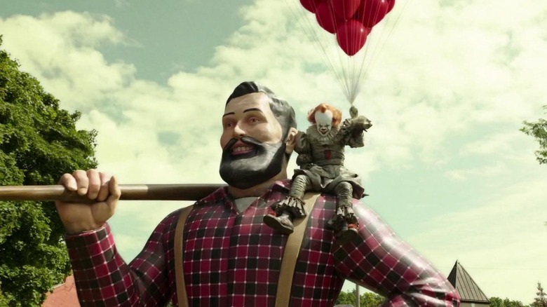 Pennywise hanging out on a statue in It: Chapter Two