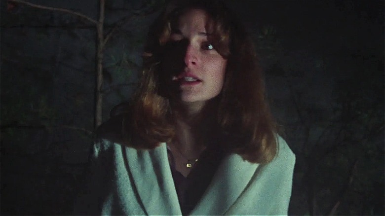Cheryl looking scared in the woods outside in "The Evil Dead"