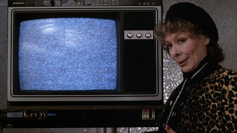 Masha standing in front of a TV with a static screen in "Videodrome"
