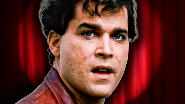Henry Hill in Goodfellas, against a red spotlight curtain (1990)