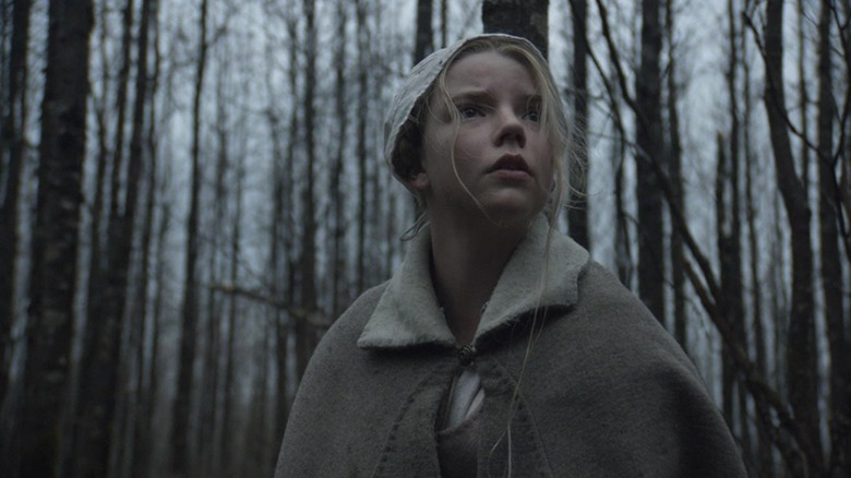 Thomasin looking around in the woods in "The Witch"