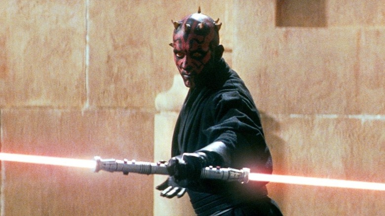 Darth Maul holding his dual-blade lightsaber in Star Wars: Episode I - The Phantom Menace