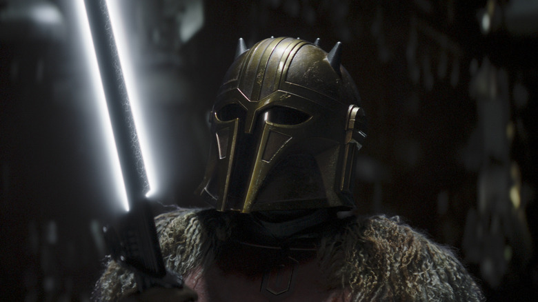 The Armorer holding the Darksaber on The MandLalorian