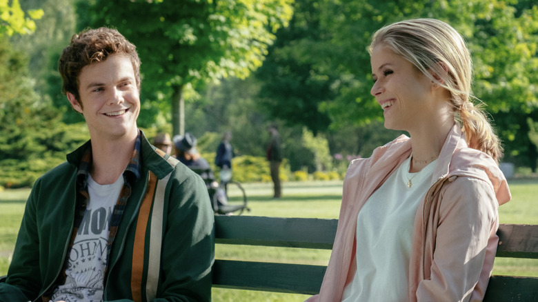 Hughie Campbell and Annie January smiling on a park bench on The Boys