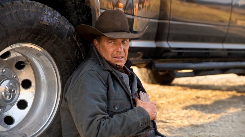 A wounded John Dutton (Kevin Costner) leaning against his truck on "Yellowstone."