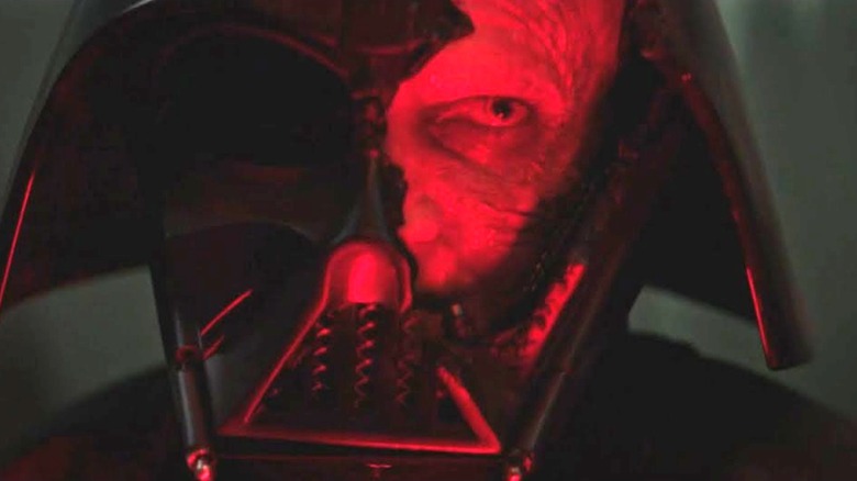 A closeup of Anakin Skywalker seen through a break in Darth Vader's mask in "Obi-Wan Kenobi"