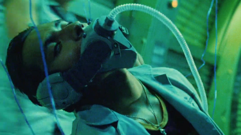 Memo Cruz hooked to wires and a face mask in "Sleep Dealer" (2008)