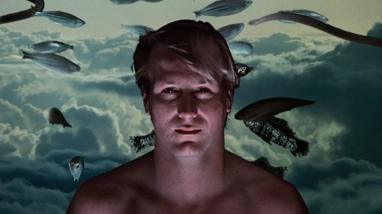 Eddie Jessup with fish behind him in Altered States