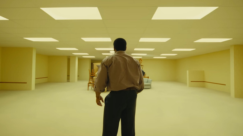 Clark staring at furniture in "Backrooms"