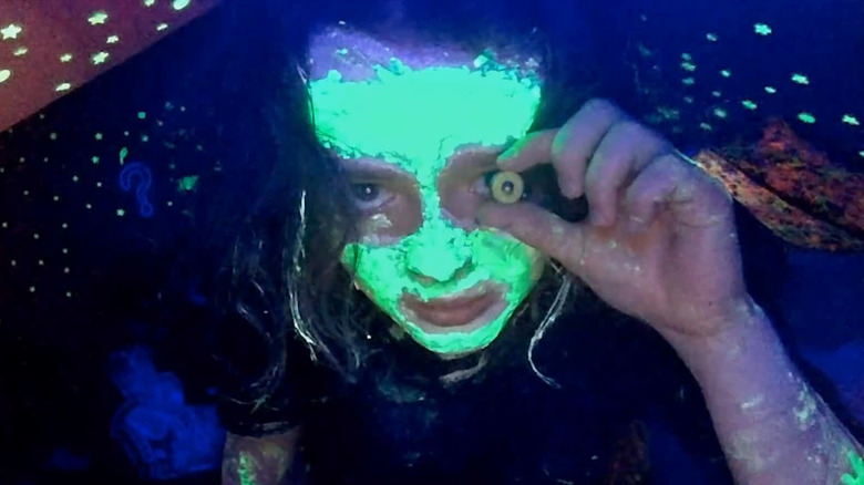 Casey holding a washer toward her eye in "We're All Going to the World's Fair"