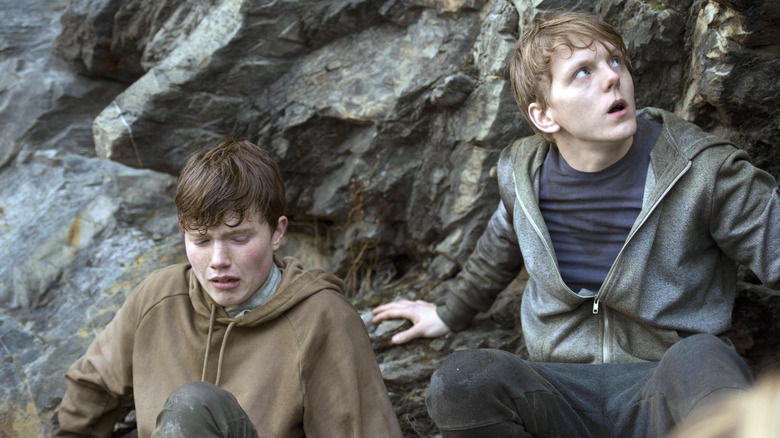 Viljar and his brother hiding near some rocks in 22 July