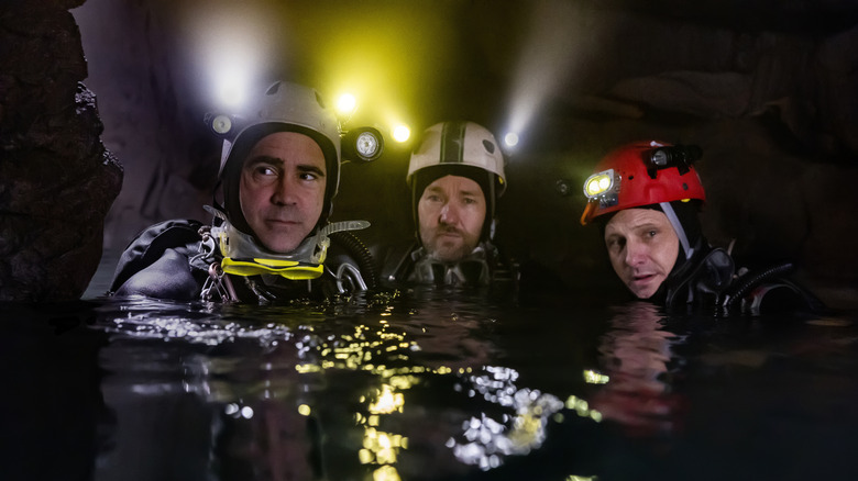 The team of cave divers submerged in water in Thirteen Lives
