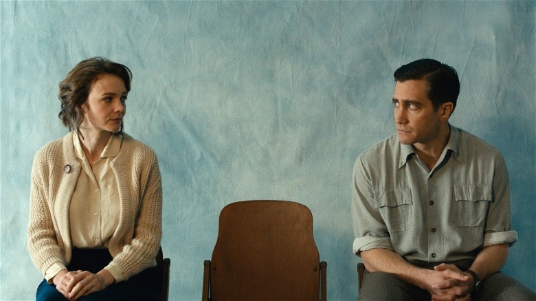 Jeanette (Carey Mulligan) and Jerry (Jake Gyllenhaal) stare at each other across an empty chair in Wildlife