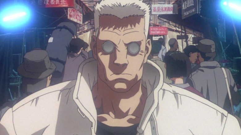 Batou standing in a busy street in 
