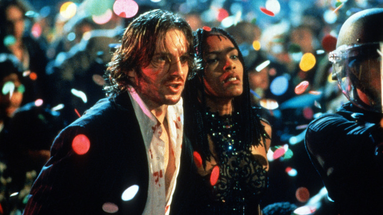 Lenny helps Mace through a crowd in "Strange Days" (1995)
