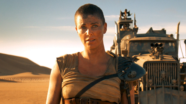 Furiosa standing in front of her rig in Mad Max: Fury Road