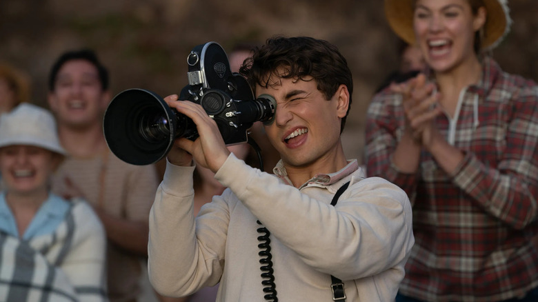 Sammy operating a camera in front of cheering people in The Fabelmans