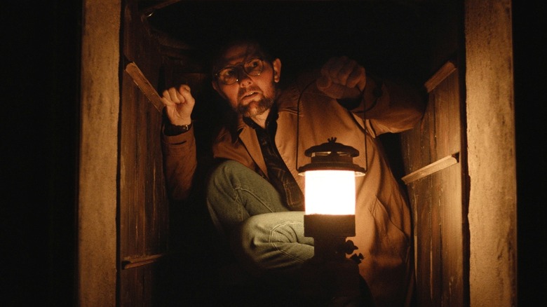 Ohm Bauman traveling down a risky dumbwaiter in Hokum (2026)