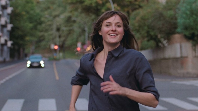 Julie running down the street smiling in The Worst Person in the World