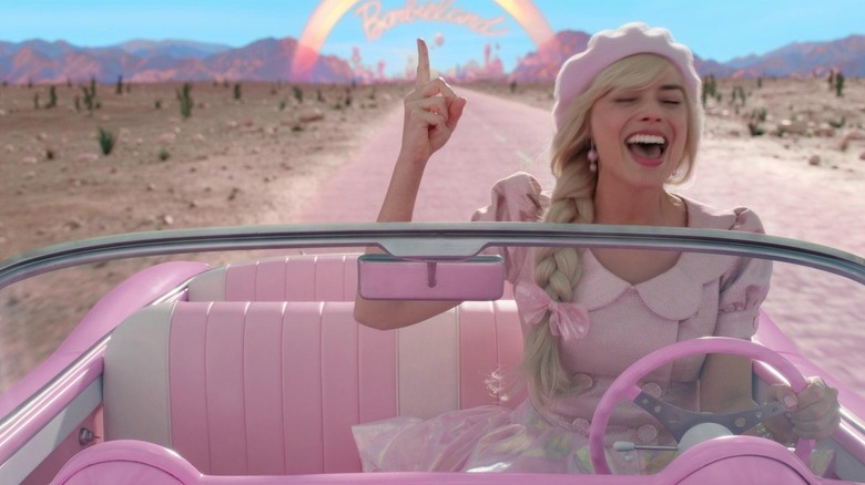 Barbie singing in a pink car in "Barbie" (2023)