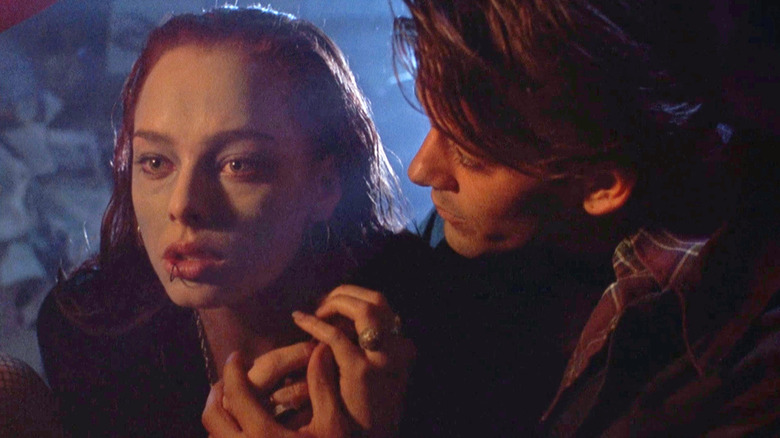 Curt Reynolds looks at a shivering Julie Walker in "Return of the Living Dead 3" (1993)