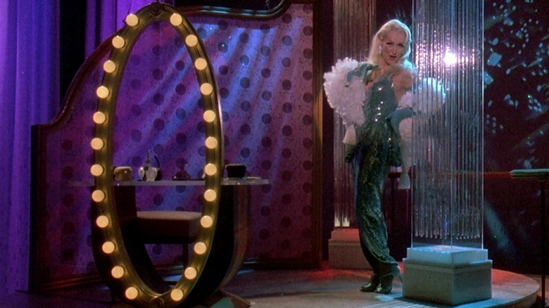 Madeline Ashton in green dress on small stage