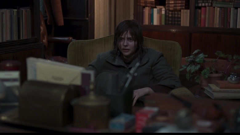 Patricia Hingle sitting at desk with matted hair