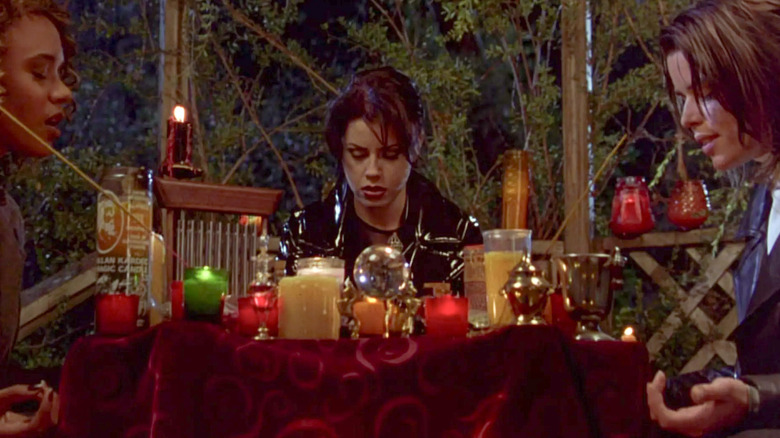 Bonnie, Nancy, and Sarah sitting around table filled with candles