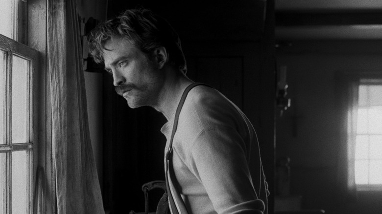 Ephraim Winslow gazing out the lighthouse window in The Lighthouse (2019)