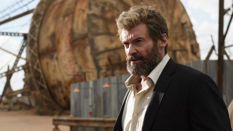 A weary Logan standing outside his shelter in "Logan" (2017)