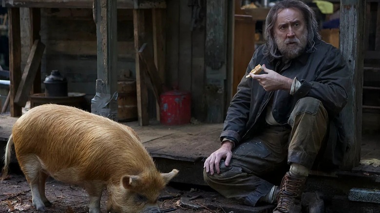 Robin "Rob" Feld sitting with his swine pal in "Pig" (2021)