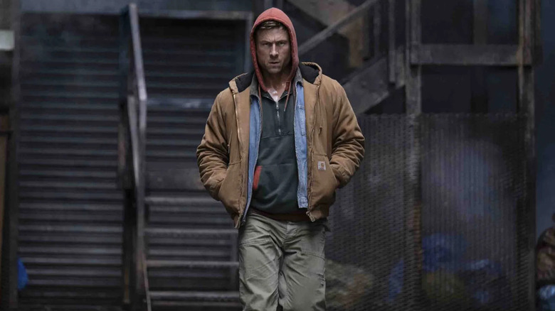 Ben walking in a hoodie in The Running Man