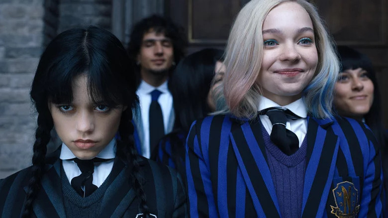 Wednesday Addams and Enid Sinclair in school uniform in "Wednesday"