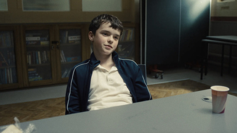 Jamie smirking at a table in Adolescence