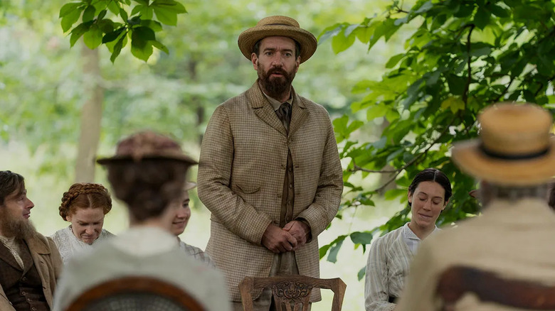 Guiteau standing in front of a crowd in a dirty jacket in Death by Lightning