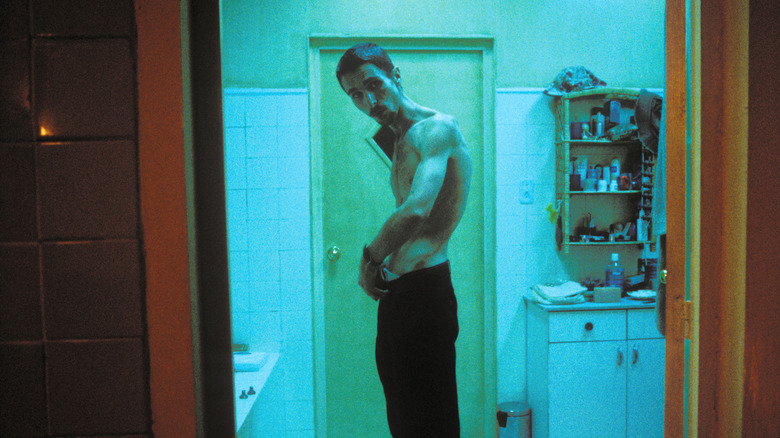 Trevor Reznik looking at himself shirtless in a mirror in "The Machinist"
