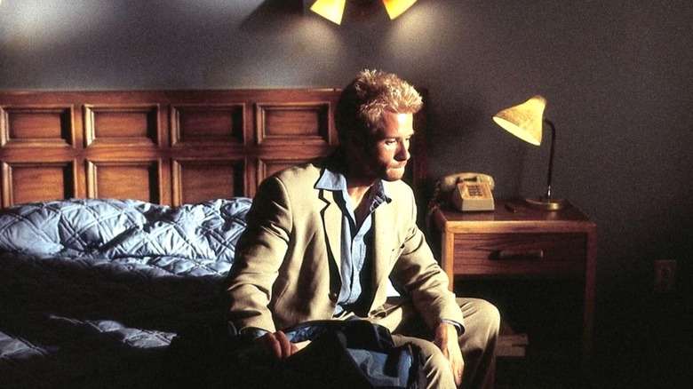 Leonard sitting on a bed in "Memento."