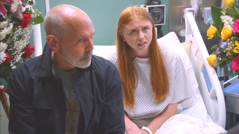 Emily sits in a hospital bed with her father beside her in NCIS