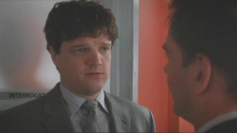 Dorneget talks to another agent in the hallway in NCIS