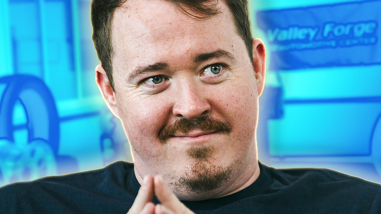 Shane Flannigan from Tires scheming in front of a blue backdrop (2026)
