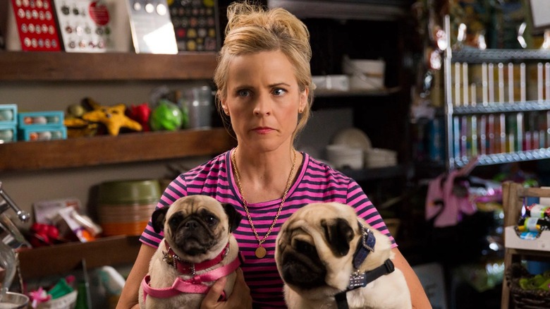 Maria Bamford looking concerned while holding her two pugs in Lady Dynamite (2017)