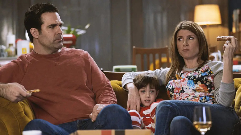 Rob and Sharon eating pizza on the couch with