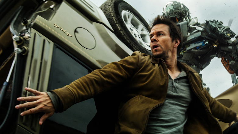 Cade Yeager hiding from an enemy Transformer in "Transformers: Age of Extinction" (2014)