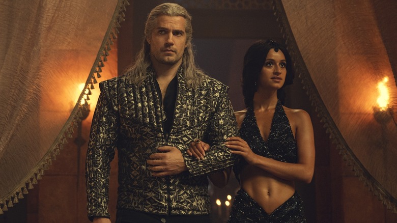 Henry Cavill's Geralt of Rivia walking with Anya Chalotra's Yennefer of Vengerberg in The Witcher