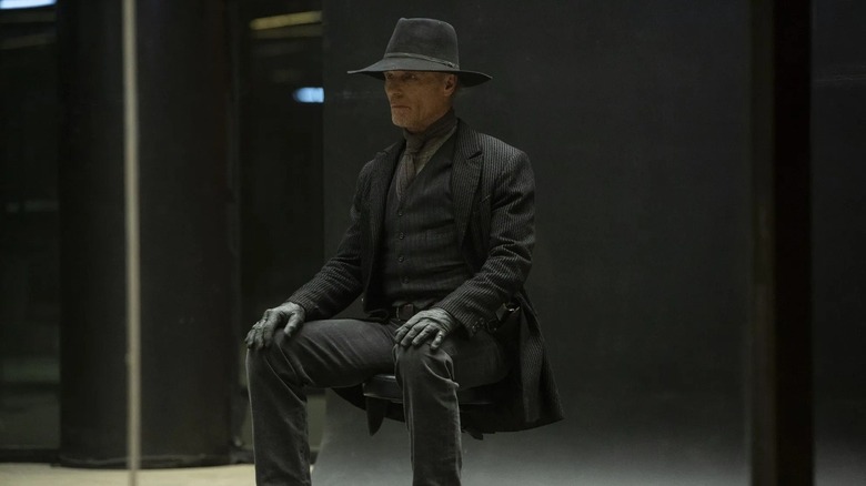 The Man in Black sitting in a chair in Westworld